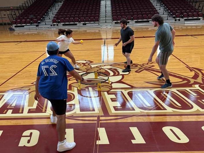 Physical Education students teaching middle school students in gym 